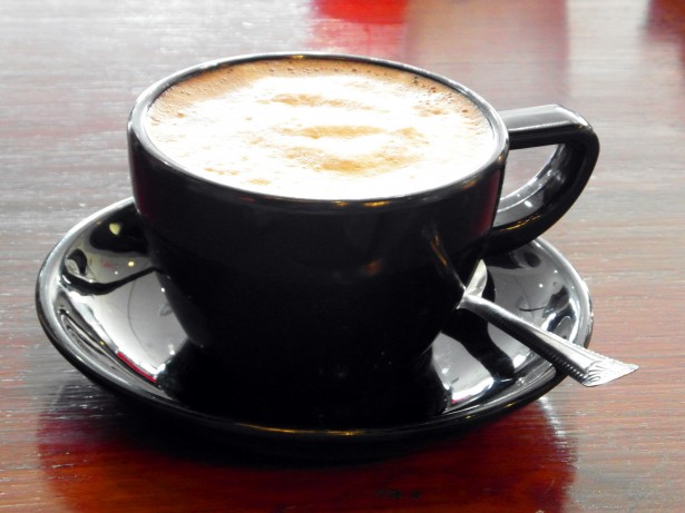 image of latte in a black coffee cup